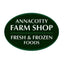 An oval dark green sign with white text reading 'ANNACOTTY FARM SHOP' and 'FRESH & FROZEN FOODS' on a plain white background.