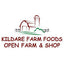 A logo for Kildare Farm Foods Open Farm & Shop featuring a small red barn and silo illustration above red text on a white background.